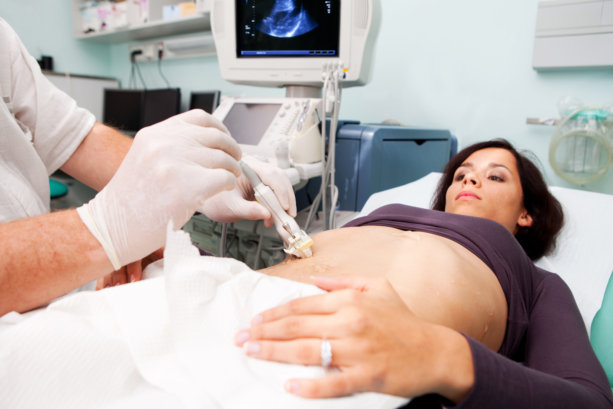 Doctor is performing liver biopsy to  woman...supporting with Ultrasound