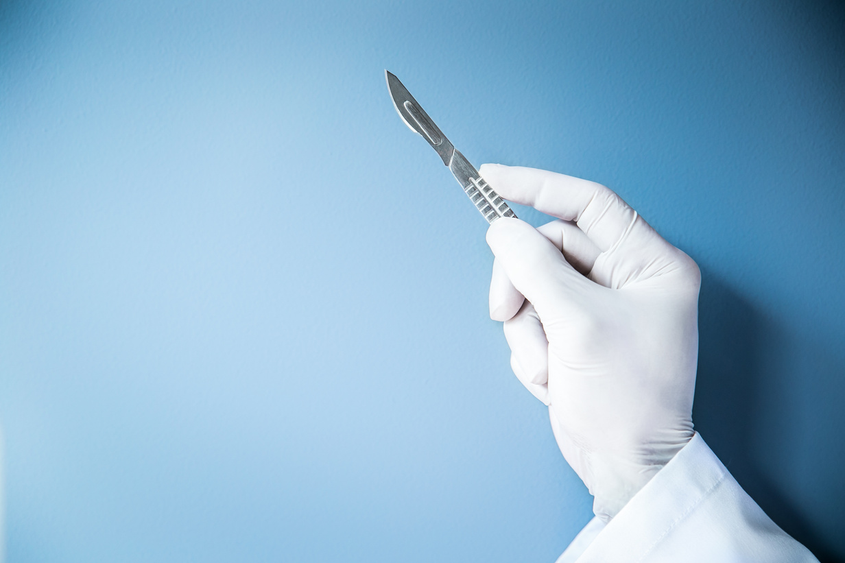 Hand of surgeon, scalpel